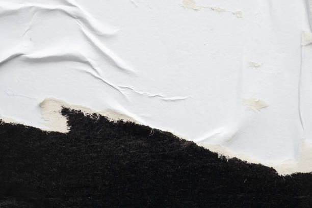 istock Old grunge ripped torn black paper poster surface texture background 2168900363