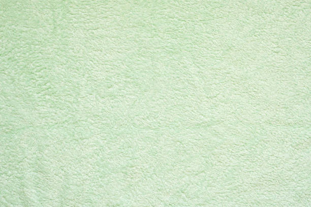 Green towels on the massage table in beauty salon. No people