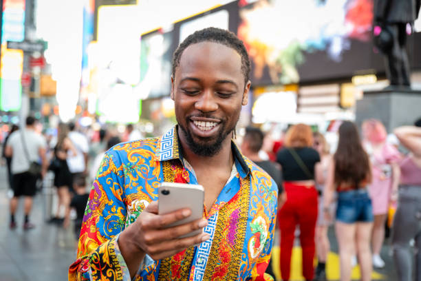 istock Young black gay man using smartphone in Times Square 2168900840