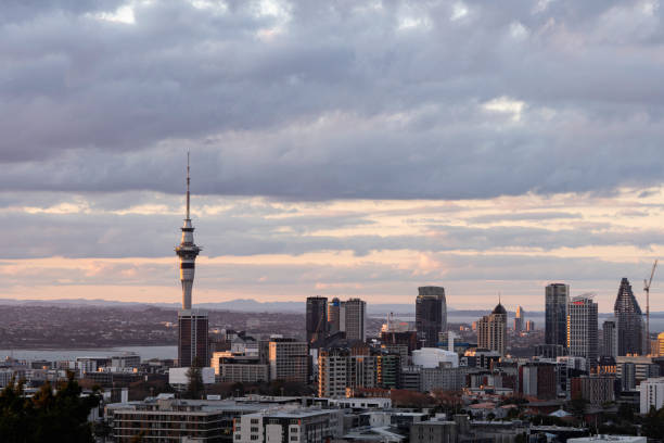 Auckland skyline under a dramatic cloudy sky at sunset
