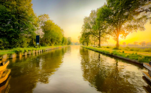istock The Serene Sunrise Over a Tranquil River is Beautiful and Surrounded by Lush Greenery 2168901821