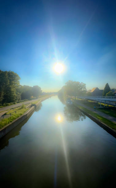 istock At dawn, the serene sunrise casts a warm and tranquil glow over the gently flowing river 2168901822