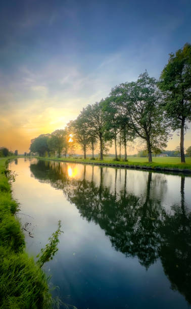istock A stunning and tranquil river sunset featuring beautifully reflective trees in the scene 2168901891