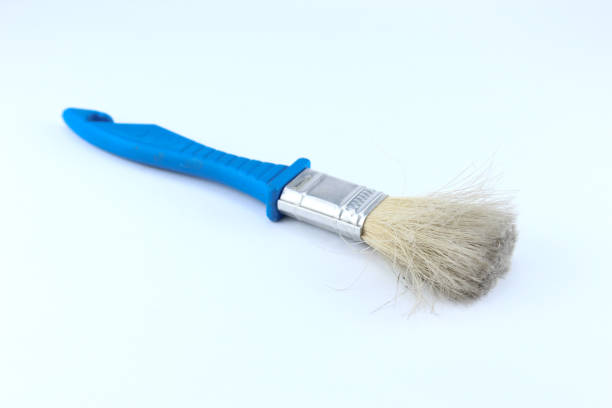 istock a used blue handled paintbrush with dirty and messy bristles on a isolated white background 2168907547