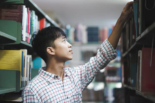 istock Man Searching for a Book in the Library 2168908387
