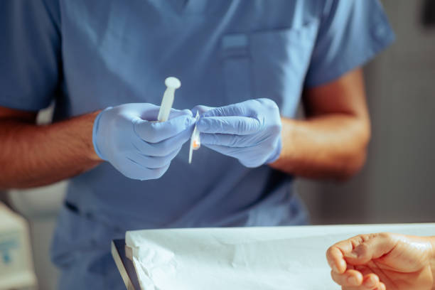 istock Doctor Preparing the Injection with Anesthesia for Surgery 2168911592