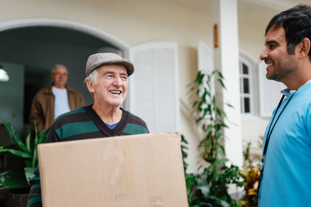 istock Elderly man holding a box with donations 2168913323