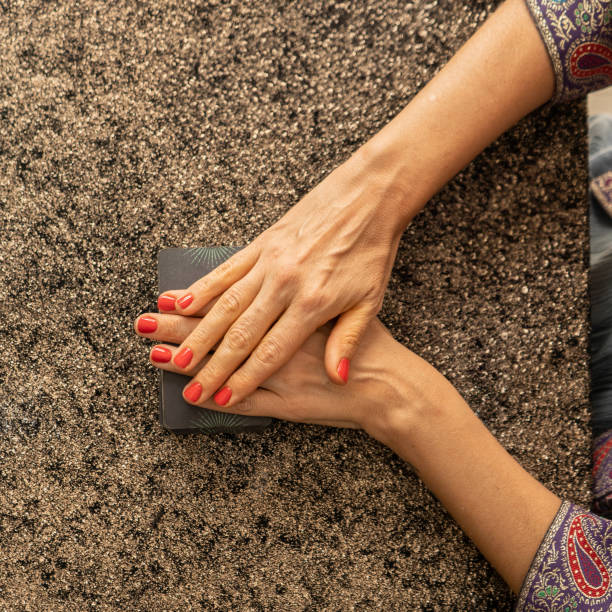 istock Top view of a tarot reader's hands over the tarot deck 2168914323