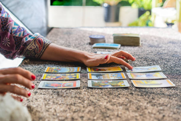 istock Side view of a tarot reader's hands reading the cards 2168914395