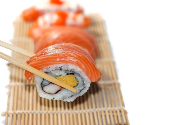 istock Sushi salmon slices serving on bamboo mat in white background with isolated concept. 2168917984