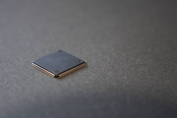 Close-up of a semiconductor IC on a black background.