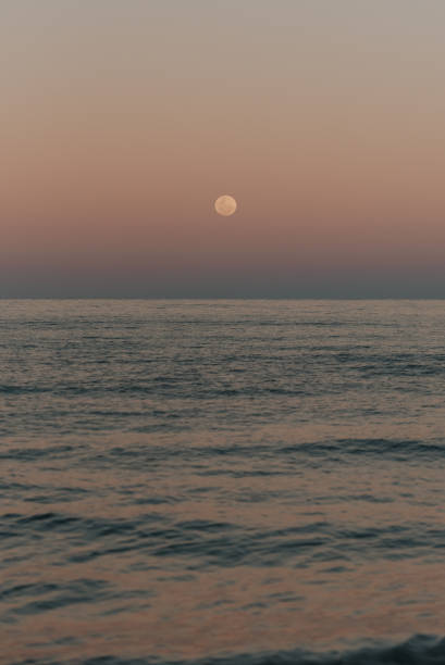 istock Full moon rising over the ocean at dusk 2168923612