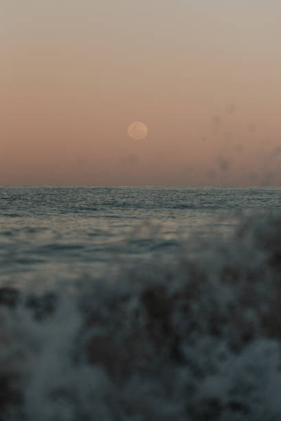 istock Full moon rising over the ocean at dusk 2168925450