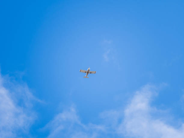 istock Small ultralight airplane with overhead wing and single propeller flying in sunset sky. 2168928429