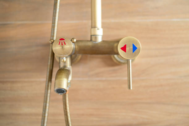 Rain shower faucet valve temperature control handle with luxury design that made from brass alloy material, close-up. Interior household equipment and object, selective focus.