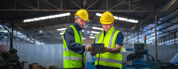 istock Two men in safety gear are looking at a tablet 2168936746