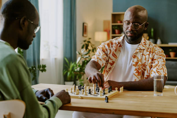 istock Two African American Men Playing Chess Game 2168942960