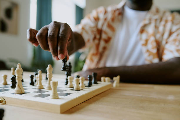istock Unrecognizable Male Player Moving Pawn Piece 2168943336