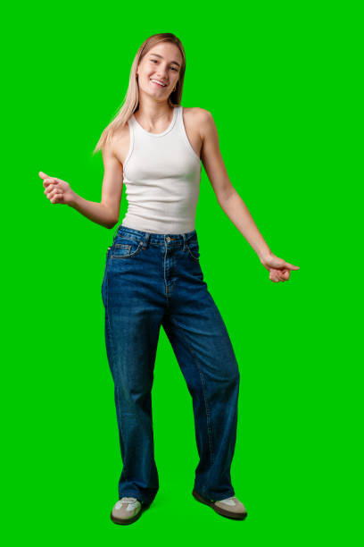 istock Young Woman Dancing in Front of a Green Screen 2168943571