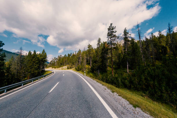 istock Scenic Mountain Road Curving Through Forested Landscape 2168943963