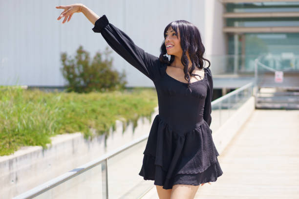 istock Vital woman raising hand while dancing under the sun 2168948080