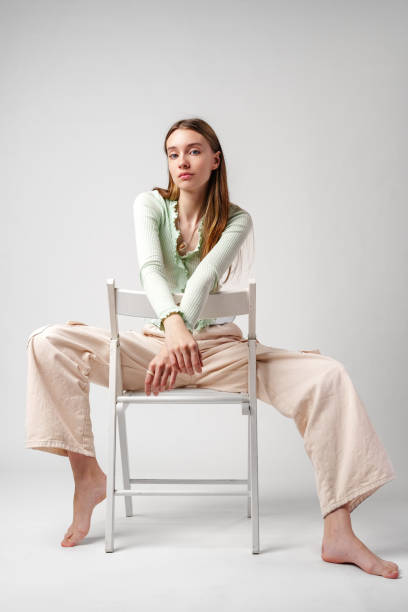 Young Woman Model Sitting and Posing in Studio portrait