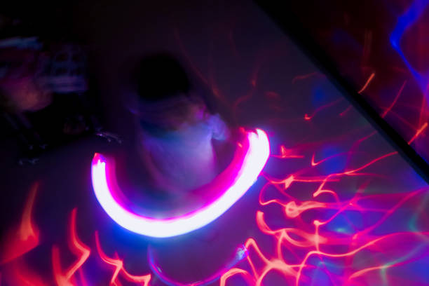 Girl waving around glow stick, playing with abstract light