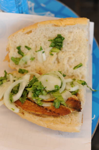 istock Fish sandwhich with grilled mackarel, raw onion in white wheat bread roll. Delicious taste. 2168951053