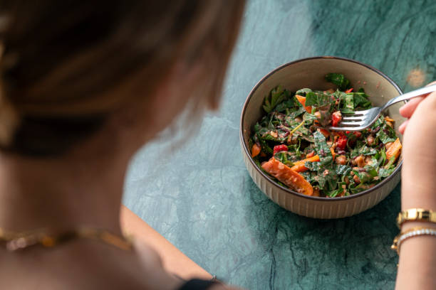 istock woman eating a healthy salad. 2168951348