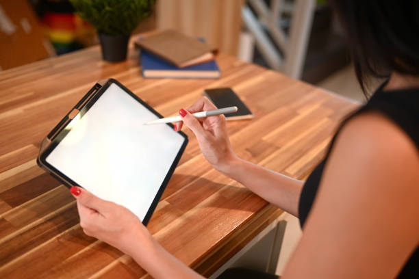 istock Close up image of young woman using digital tablet at kitchen counter 2168952095