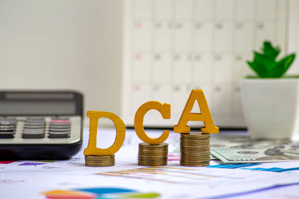 istock DCA text on wooden blocks on growth of coins stack. Background for Dollar cost averaging investment strategy, Saving stock monthly, Quarterly basis. Fund purchases, Business and investment concept. 2168954974