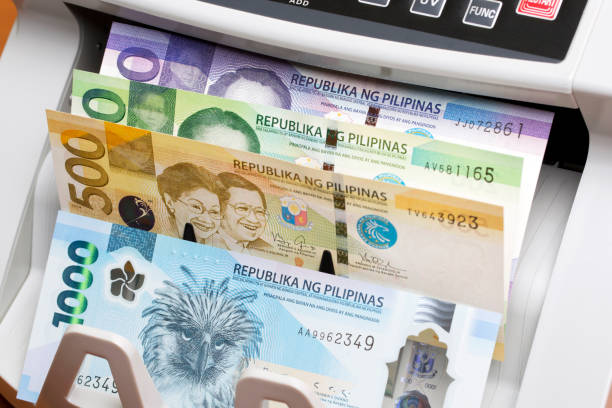 istock Philippine peso in the counting machine 2168954983