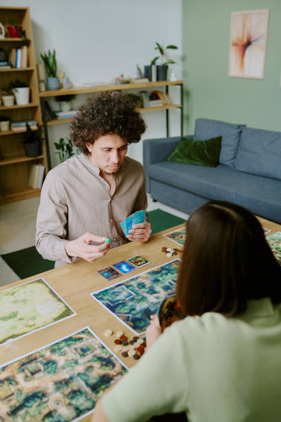 istock Young Man And His Girlfriend Playing Tabletop Game 2168957824