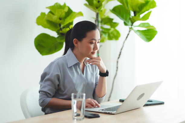 istock Asian woman enjoy with working online using laptop sitting at home office. 2168958024