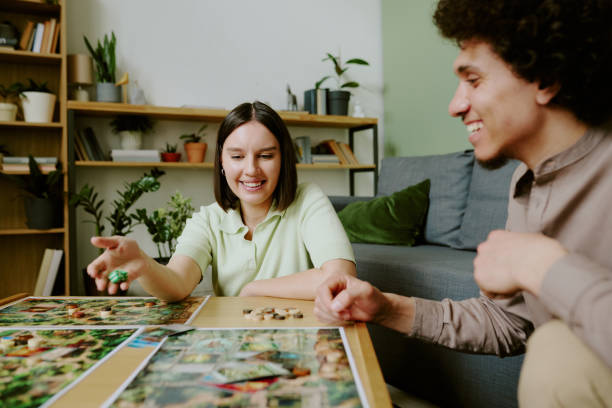 istock Cheerful Man And Woman Playing Board Game 2168958854