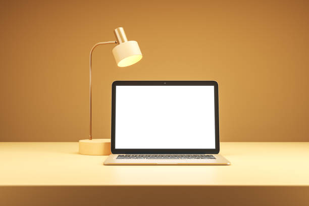 istock Modern desk setup with laptop and lamp on a light orange background. 3D Rendering 2168959058