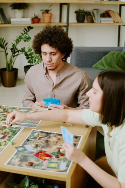 istock Young Man and Woman Playing Modern Board Game 2168959932