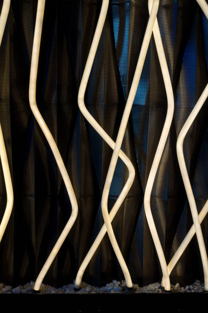 istock Modern lighting installation featuring intertwined white light tubes against a dark background. Contemporary design, architectural lighting, and creative illumination projects. 2168960798
