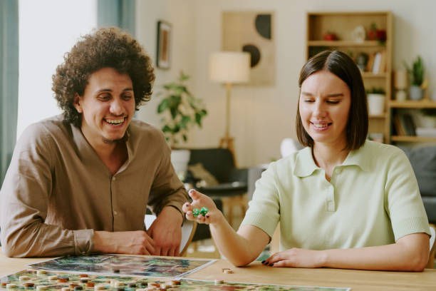 istock Man And Woman Playing Roll-And-Move Game 2168961085