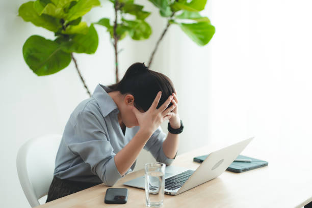 istock Asian woman using laptop suffering from problem with work or financial. 2168961446