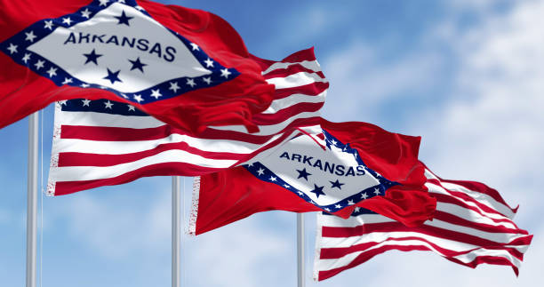 istock Arkansas state flags waving with the American flags on a clear day 2168962236
