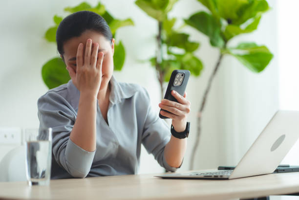 istock Asian woman using smartphone suffering from problem with work or financial. 2168962941