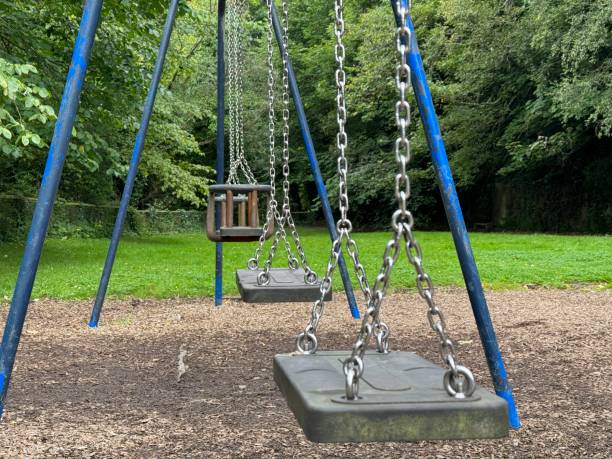 istock Empty children’s swings in a public park 2168964178