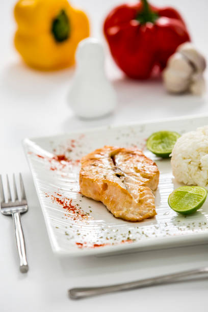 salmon fish fillet with rice on a plate lemon on the side restaurant menu shoot