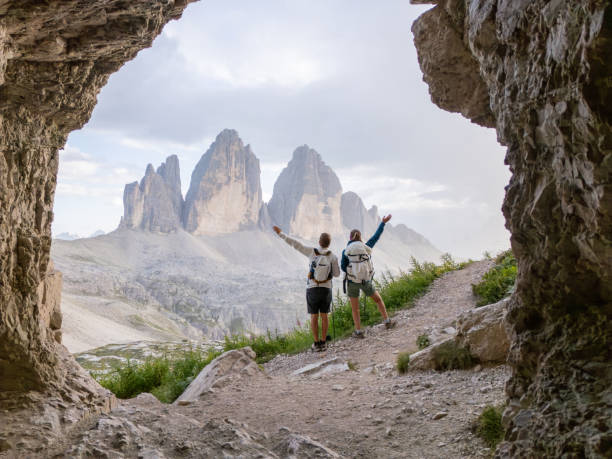 istock Hikers Celebrating at Cave Entrance with Mountain View 2168966858