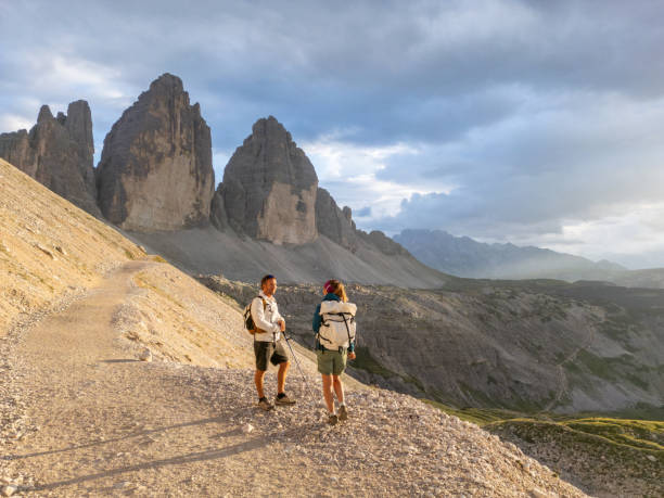 istock Hikers Trekking Along Mountain Path at Sunset 2168967101