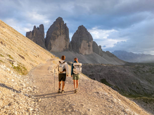 istock Hikers Trekking Along Mountain Path at Sunset 2168967261