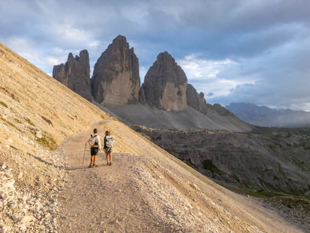 istock Hikers Trekking Along Mountain Path at Sunset 2168967272