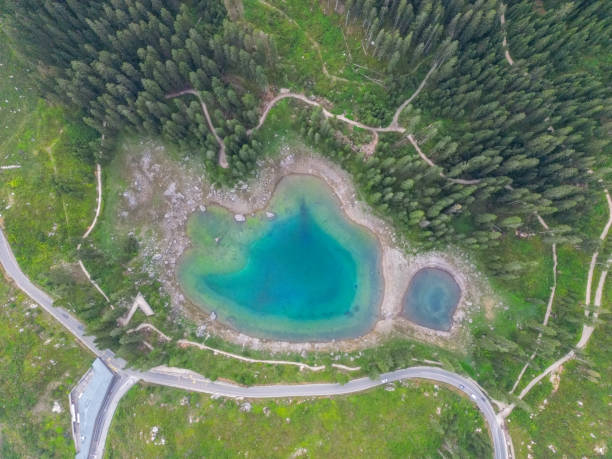 istock Aerial View of Turquoise Alpine Lake Surrounded by Forest 2168967310