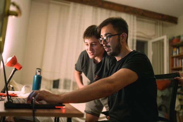 istock Family playing computer game together on laptop at home. 2168970352
